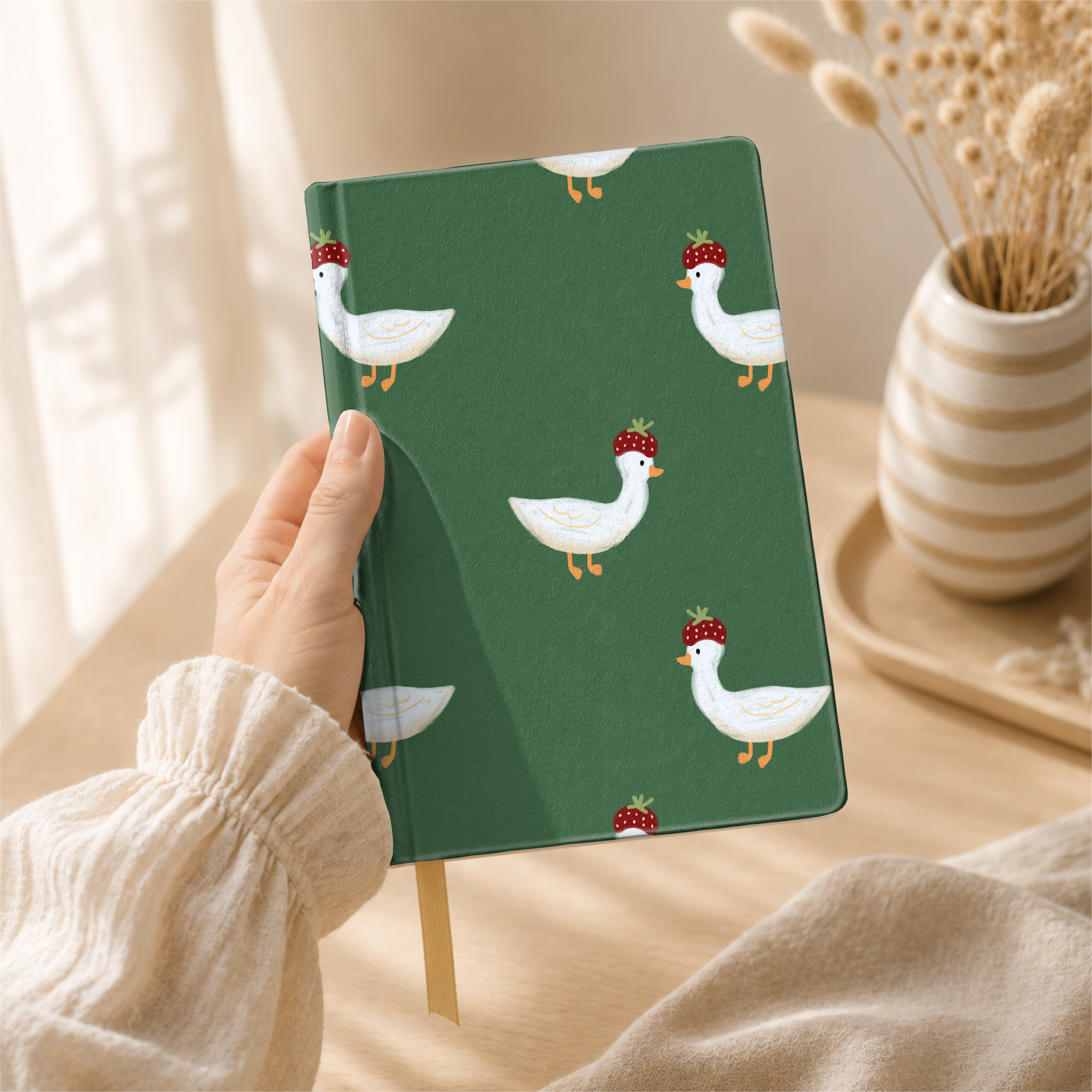 Strawberry.hat.goose 0 pattern shown on a notebook mockup