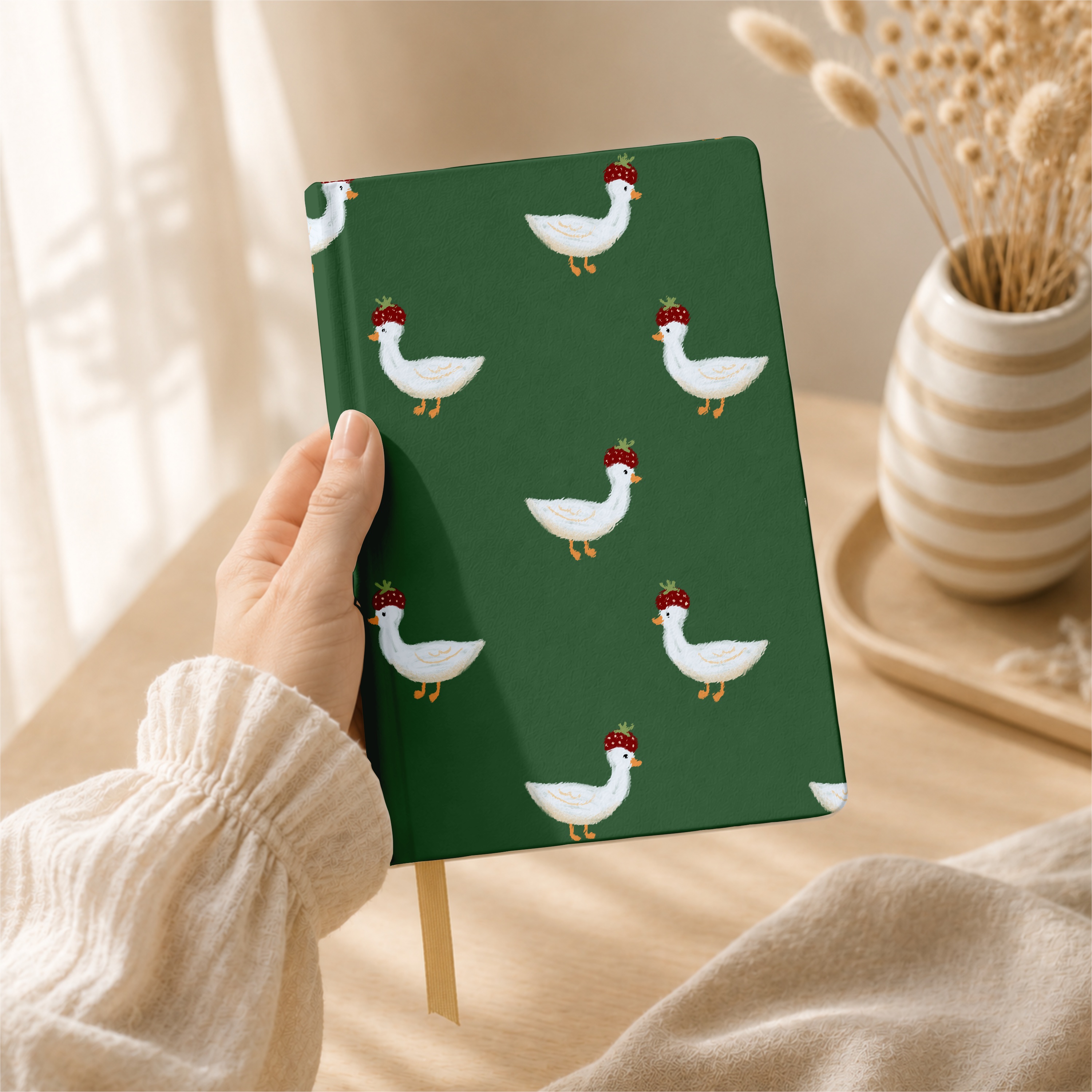 Strawberry.hat.goose 0 pattern shown on a notebook mockup
